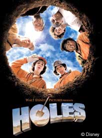 poster for Holes movie; seven teenagers looking down into hole
